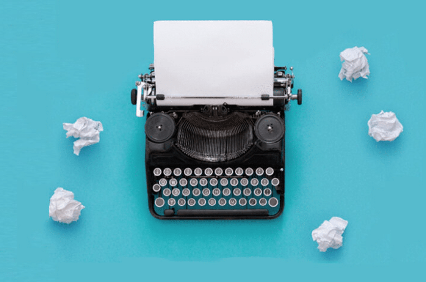 A typewriter with paper and crumpled paper Description automatically generated